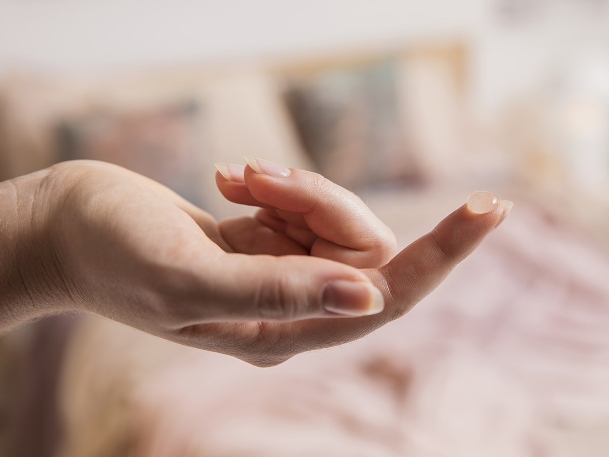 hand with a bit of the product on finger